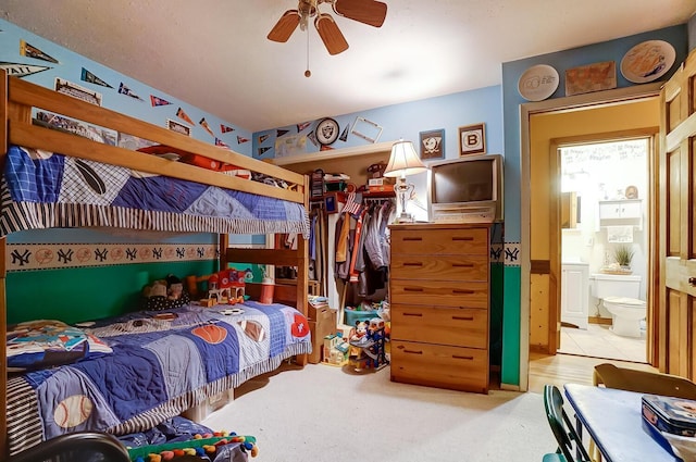 bedroom with ceiling fan and connected bathroom