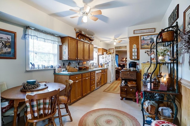 kitchen featuring dishwasher, backsplash, and white fridge