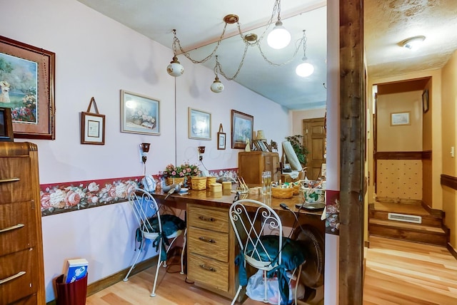 home office featuring a textured ceiling and hardwood / wood-style flooring