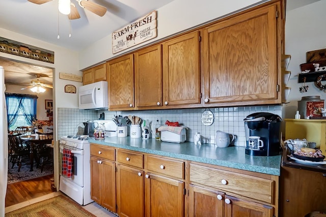 kitchen with light wood-type flooring, white appliances, and backsplash