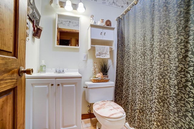 bathroom with tile patterned floors, a shower with curtain, vanity, and toilet