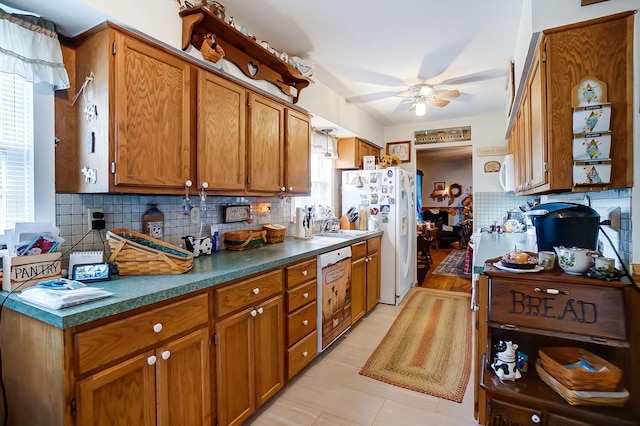 kitchen with decorative backsplash, white appliances, and ceiling fan