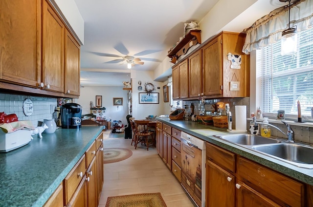 kitchen featuring decorative backsplash, dishwasher, ceiling fan, and sink