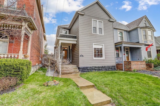 view of front of home with a front yard and covered porch