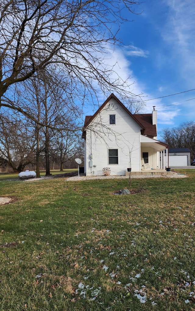 view of side of home with a porch and a yard