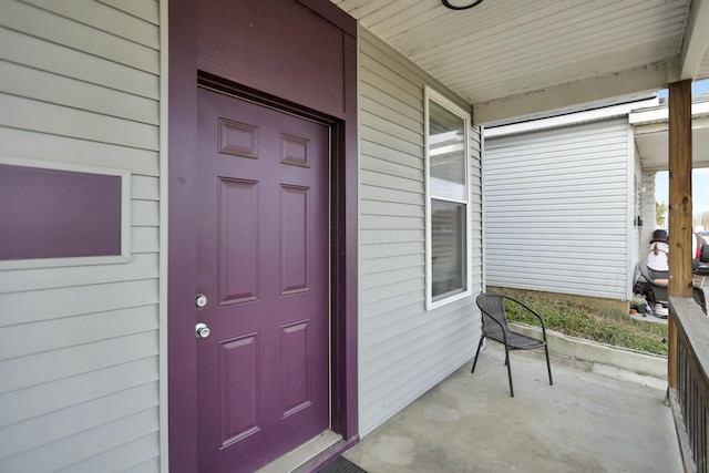 view of exterior entry featuring a porch