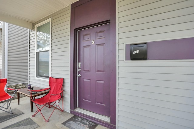 view of exterior entry featuring a porch