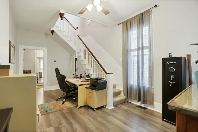 home office featuring ceiling fan and light hardwood / wood-style flooring