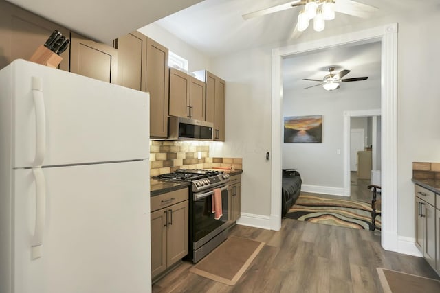 kitchen with ceiling fan, decorative backsplash, dark hardwood / wood-style floors, and appliances with stainless steel finishes