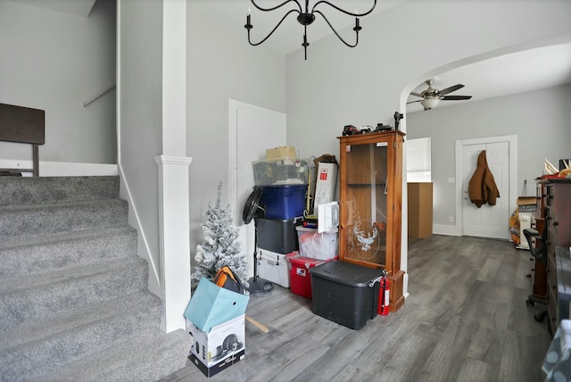 interior space featuring wood-type flooring and ceiling fan with notable chandelier