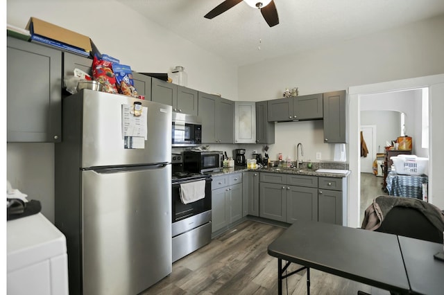 kitchen with appliances with stainless steel finishes, dark hardwood / wood-style floors, gray cabinetry, and sink