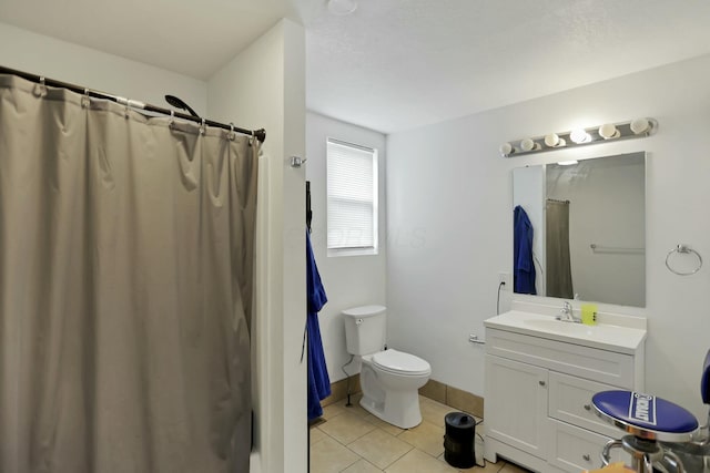 bathroom with toilet, vanity, tile patterned floors, and curtained shower