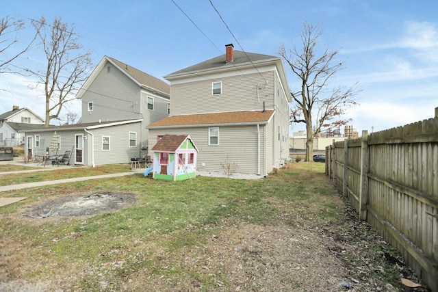 back of house with a lawn