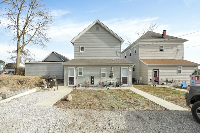 rear view of property featuring a patio