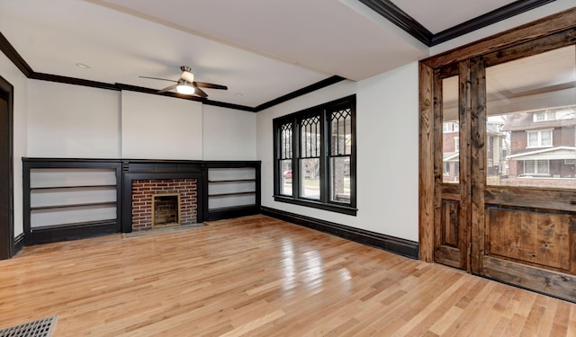 unfurnished living room with a fireplace, light hardwood / wood-style flooring, ceiling fan, and a healthy amount of sunlight