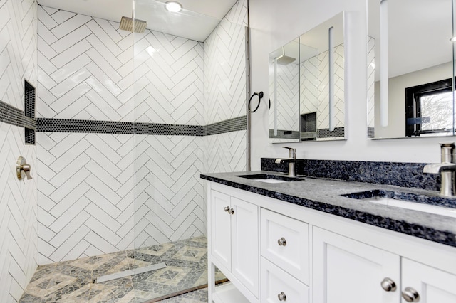 bathroom featuring vanity and tiled shower