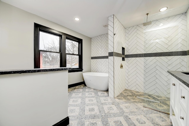 bathroom featuring vanity and shower with separate bathtub