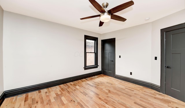 spare room with hardwood / wood-style floors and ceiling fan