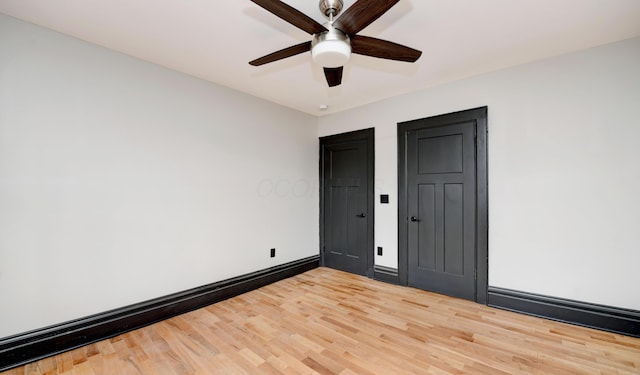 unfurnished bedroom with ceiling fan, hardwood / wood-style floors, and a baseboard radiator