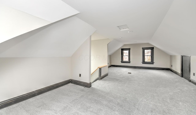 additional living space featuring light carpet and lofted ceiling