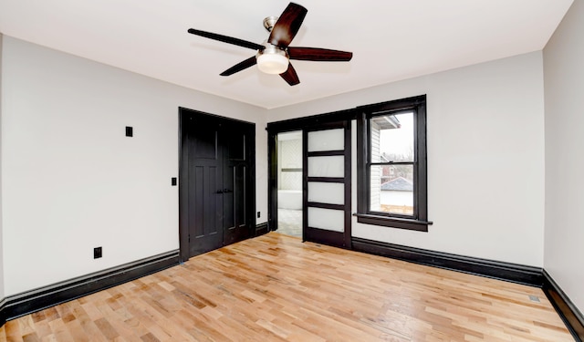 unfurnished room with ceiling fan, wood-type flooring, and baseboard heating