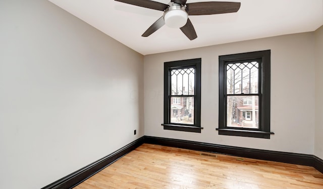 unfurnished room with hardwood / wood-style floors and ceiling fan