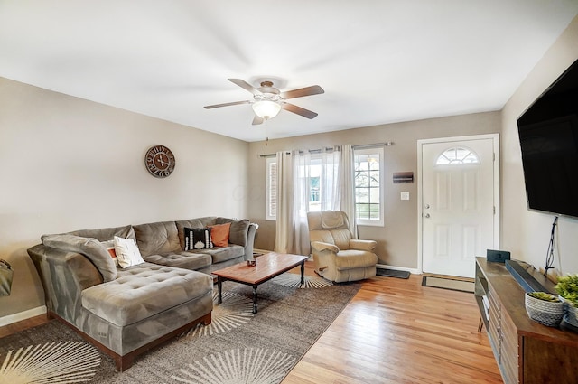 living room featuring ceiling fan and light wood-type flooring