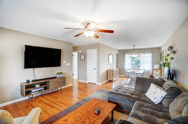 living room with ceiling fan and light wood-type flooring