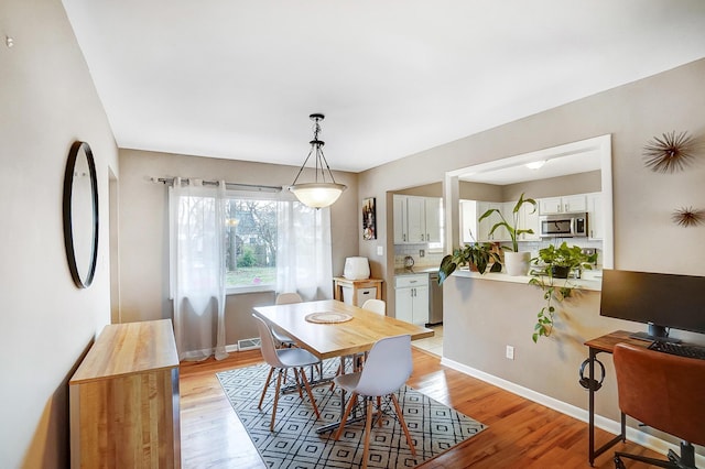 dining room with light wood-type flooring