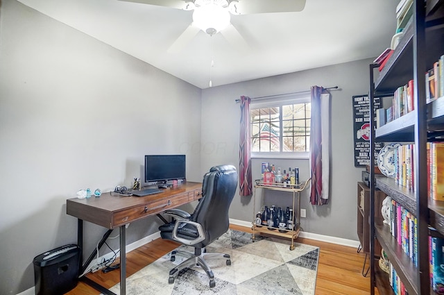 office space featuring ceiling fan and light hardwood / wood-style floors