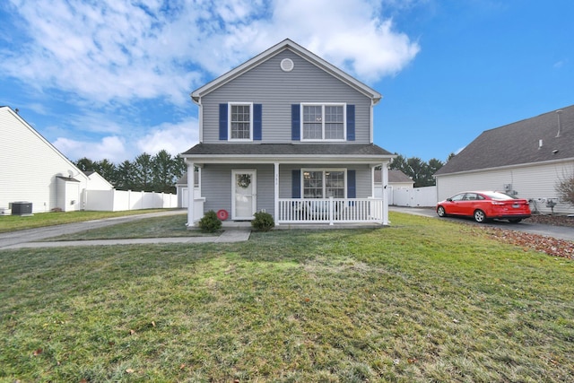 view of property featuring a porch, a front lawn, and central air condition unit