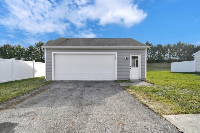 garage featuring a lawn