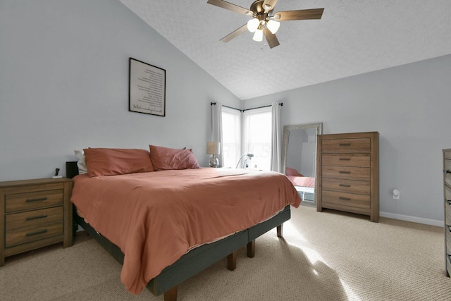 carpeted bedroom featuring a textured ceiling, ceiling fan, and lofted ceiling