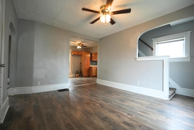 unfurnished room featuring dark hardwood / wood-style flooring, a textured ceiling, and ceiling fan