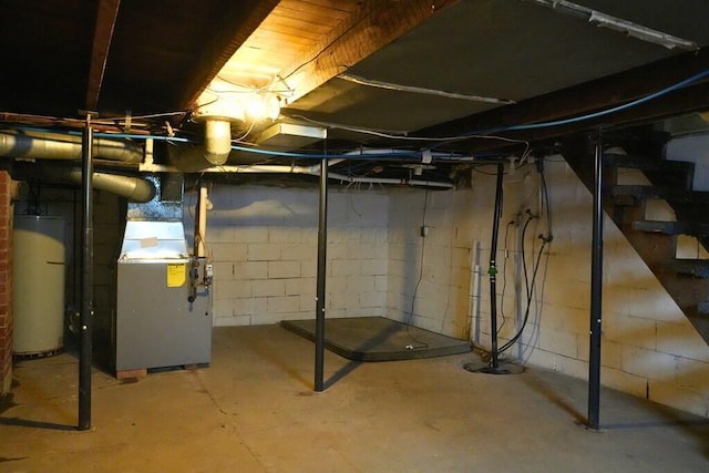 unfinished basement featuring water heater and heating unit