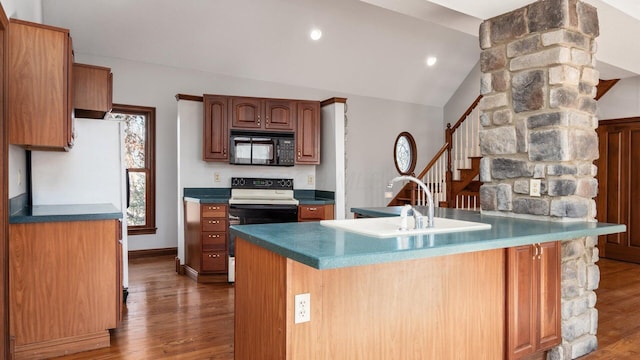 kitchen with sink, white electric range, dark hardwood / wood-style floors, lofted ceiling, and a kitchen island with sink