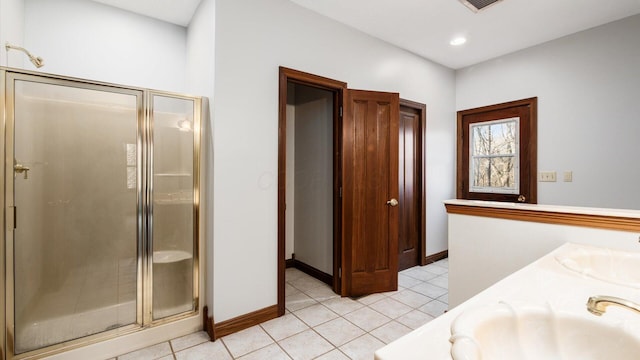 bathroom with tile patterned flooring, vanity, and a shower with shower door