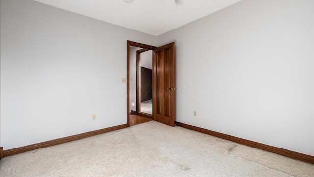 carpeted spare room with ceiling fan