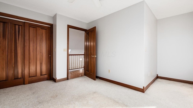 unfurnished bedroom with light carpet and ceiling fan