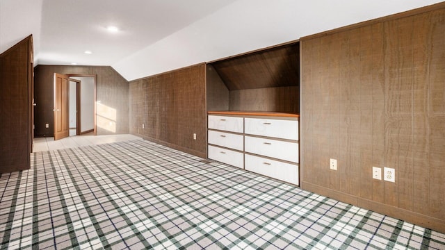 bonus room featuring wood walls and lofted ceiling