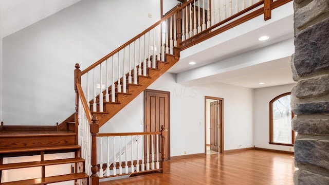 stairs with hardwood / wood-style flooring