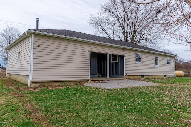 rear view of house featuring a yard