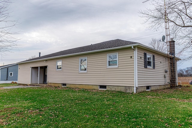 back of property with a lawn