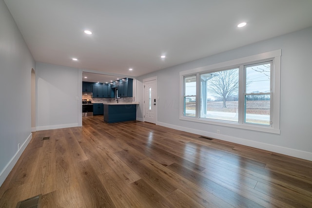 unfurnished living room with dark hardwood / wood-style floors