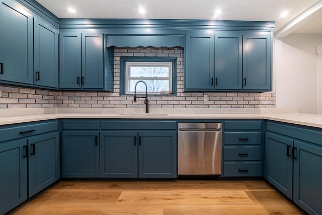 kitchen with blue cabinetry, light hardwood / wood-style floors, and sink