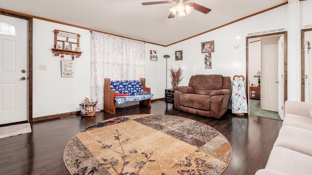 living room featuring dark hardwood / wood-style flooring, vaulted ceiling, ceiling fan, and crown molding