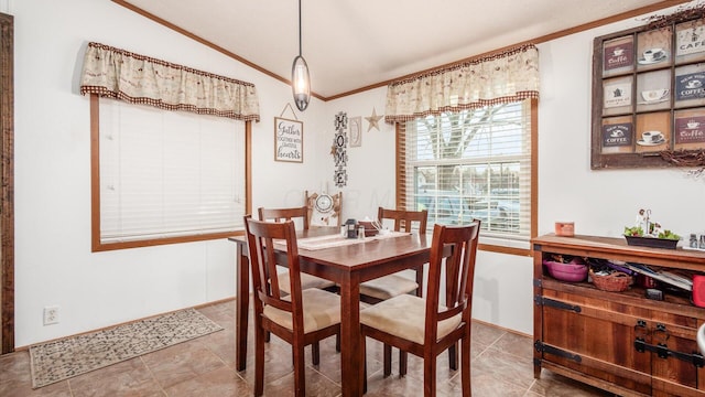 dining space featuring ornamental molding and vaulted ceiling