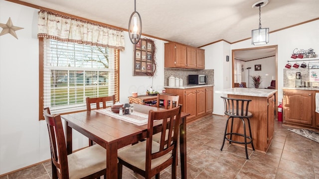 dining room featuring a textured ceiling and crown molding