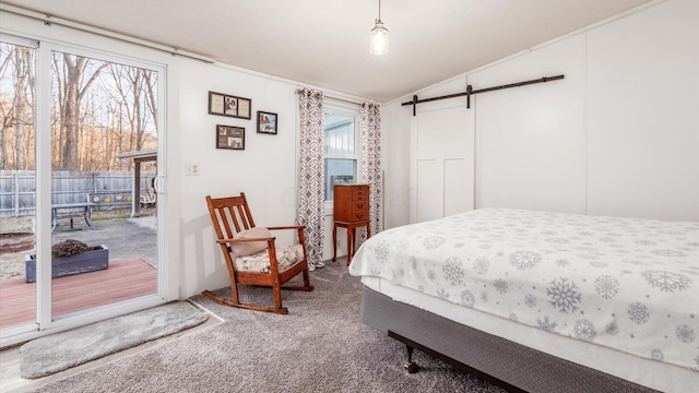 carpeted bedroom with access to outside, a barn door, and lofted ceiling