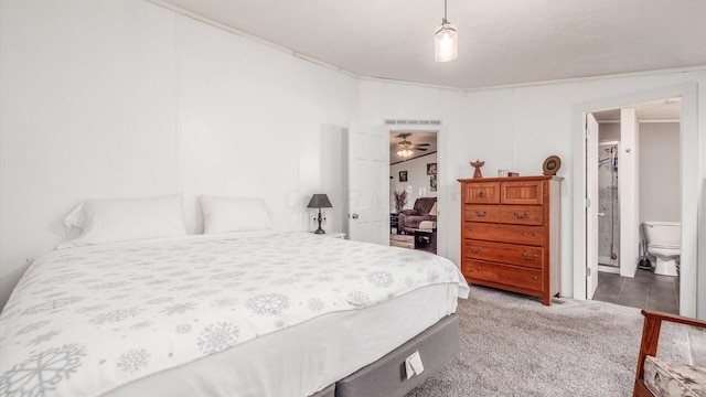 carpeted bedroom featuring ensuite bathroom